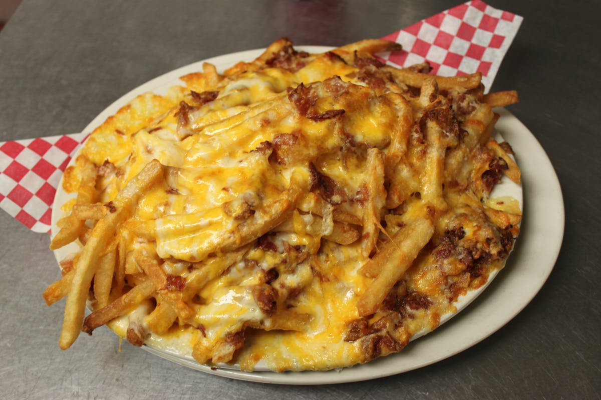 fries with chili and cheesesitting on top of a plate of food